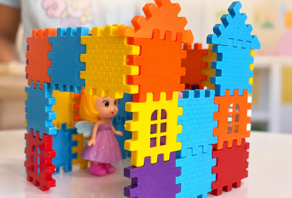 Castelo de blocos de encaixe com uma boneca dentro